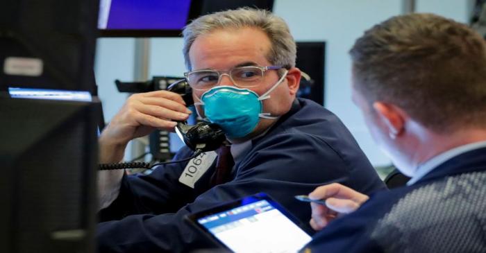 FILE PHOTO: A trader wears a face mask on the floor  of the NYSE in New York