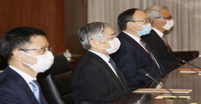 Bank of Japan Governor Kuroda wearing a protective face mask attends a quarterly meeting of the
