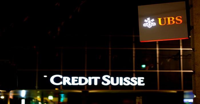 FILE PHOTO: Logos of Swiss banks UBS and Credit Suisse are seen in Basel