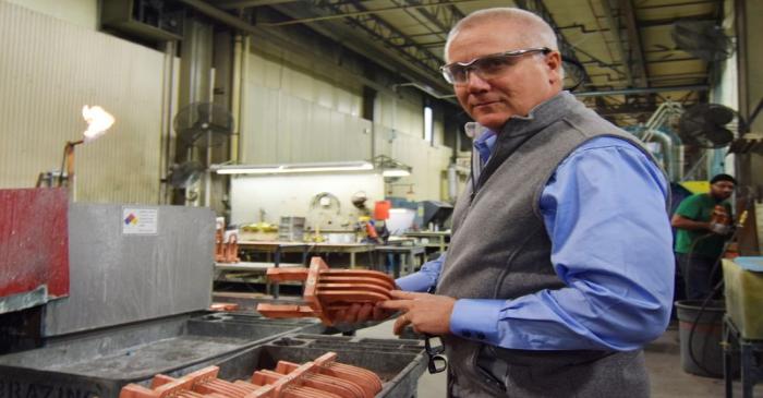 FILE PHOTO: Roth, CEO of transformer manufacturer RoMan Manufacturing holds a secondary coil