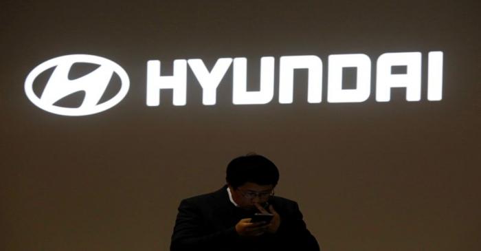 FILE PHOTO: A man walks past the logo of Hyundai Motor during the 2019 Seoul Motor Show in