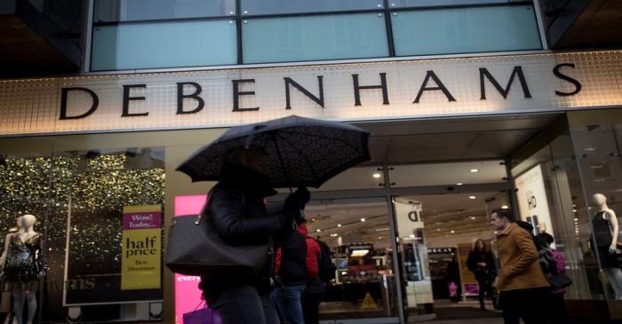 Shoppers walk past the Debenhams department store on Oxford Street in London