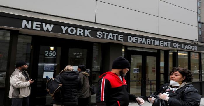 FILE PHOTO:  People gather at the entrance for the New York State Department of Labor offices,