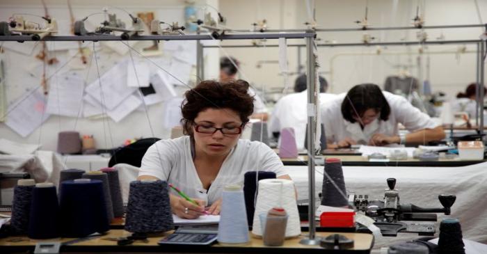 FILE PHOTO: Seamstress makes cashmere wool garments in the studio of Italian clothing designer