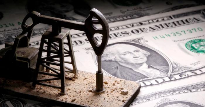 FILE PHOTO: A 3D printed oil pump jack is placed on dollar banknotes in this illustration
