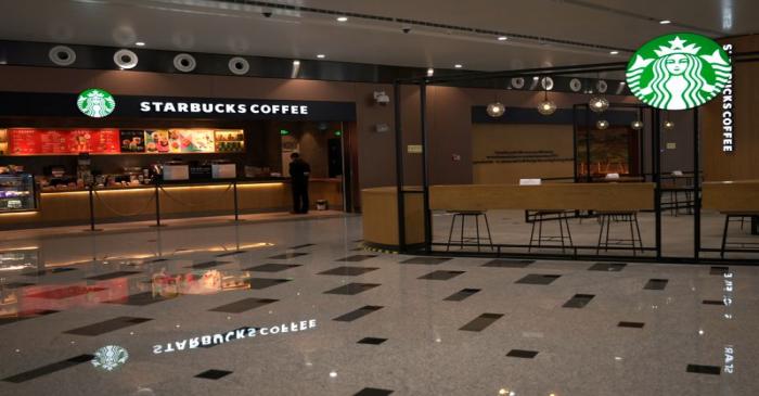 Staff member is seen at Starbucks at the Beijing Daxing International Airport, as the country