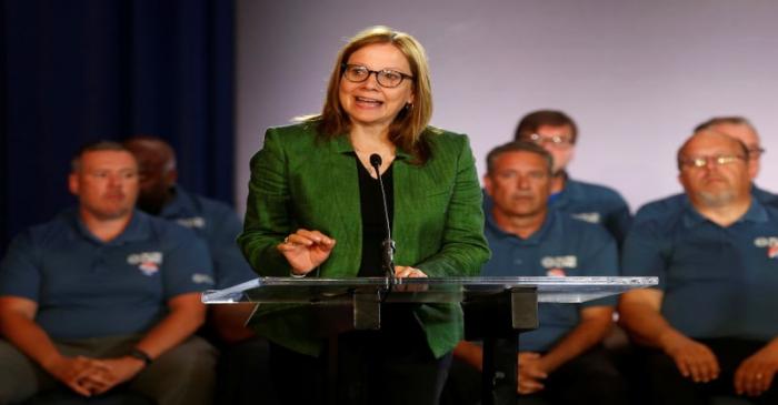 General Motors Chairman and CEO Mary Barra makes a statement as members of the United Auto