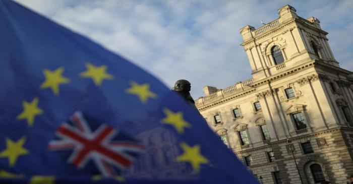 A flag is seen outside the Houses of Parliament near the statue of former Prime Minister