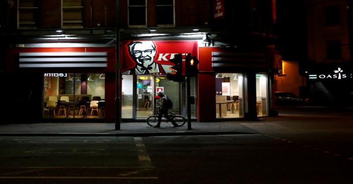 FILE PHOTO: A person walks past an empty KFC restaurant in Belfast