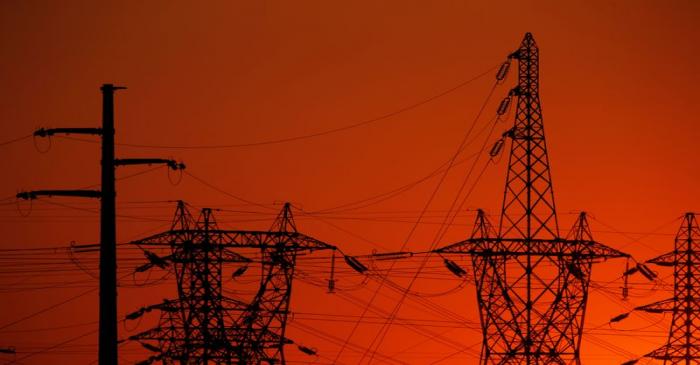 Electricity pylons are seen during sunset in Gavrelle, near Arras, France
