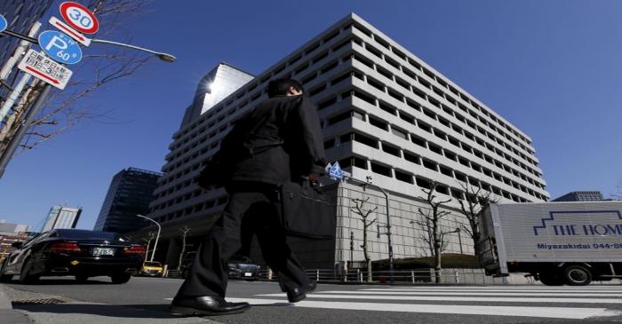 A man walks past BOJ building in Tokyo