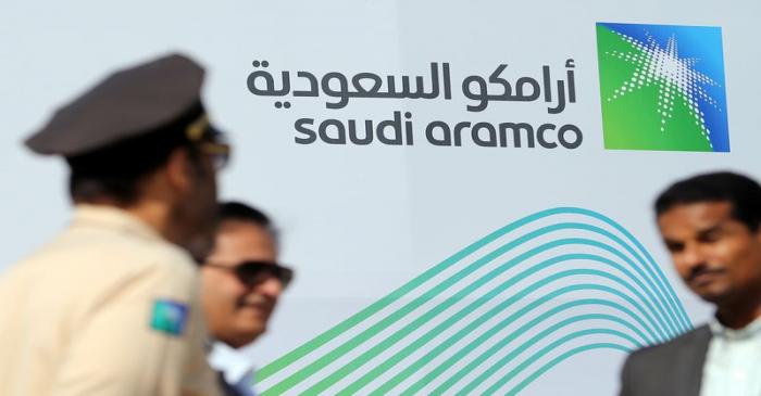 Logo of Aramco is seen as security personnel stand before the start of a press conference by