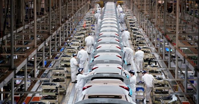 FILE PHOTO: Employees work on a production line inside a Dongfeng Honda factory in Wuhan