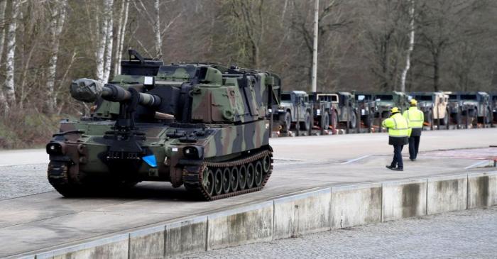 FILE PHOTO: Soldiers of German Army Bundeswehr load a U.S. M109 tank onto a heavy goods