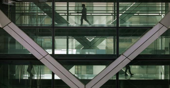 People walk in an office in the financial centre of Canary Wharf