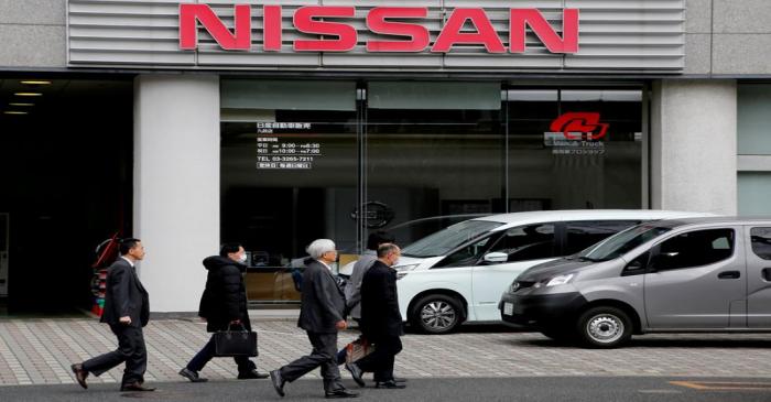 FILE PHOTO: People walk past a dealer shop of Nissan Motor in Tokyo