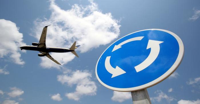 FILE PHOTO: A Ryanair Boeing 737 airplane passes a roundabout sign as it lands at Barcelona-El