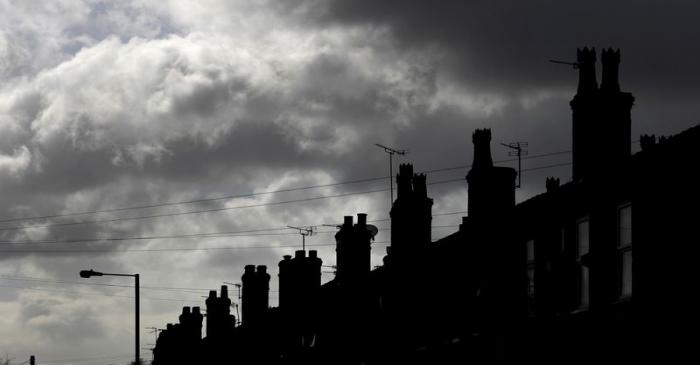 FILE PHOTO: Rain clouds gather behind a row of terraced houses in Altrincham, northern England