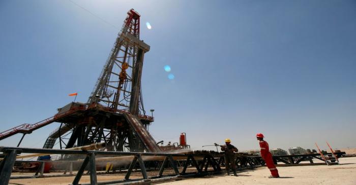 FILE PHOTO: Men work for Iraqi Drilling Company at Rumaila oilfield in Basra