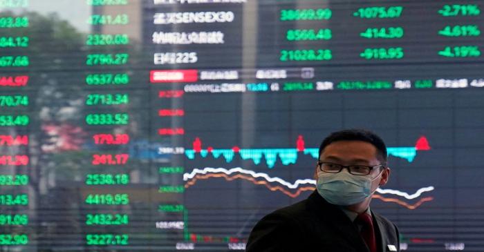 A man wearing a protective mask is seen inside the Shanghai Stock Exchange building, as the