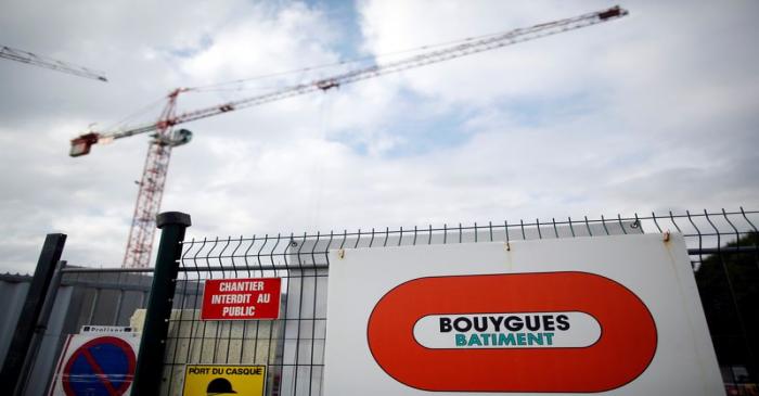 A construction crane is seen near the logo of French construction group Bouygues in Nantes