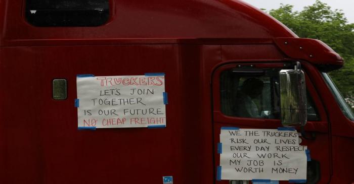 Truckers line their trucks along Constitution Ave for a protest as the outbreak of the