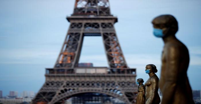 FILE PHOTO: Golden Statues at the Trocadero square near the Eiffel tower wear protective masks