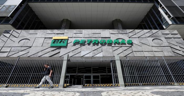 FILE PHOTO: A man walks in front of the headquarters of Petroleo Brasileiro S.A. (Petrobas) in