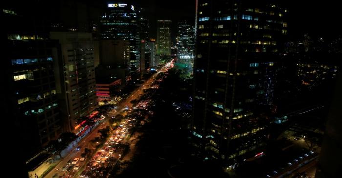 Buildings are seen as vehicles pass through the financial district of Makati city, metro Manila