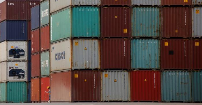 FILE PHOTO: A laborer works in a container area at a port in Tokyo