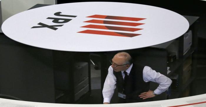 An employee of the TSE works at the bourse in Tokyo