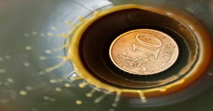 A view shows a 10 Euro cent coin is seen inside a bulb with crude oil at a laboratory in the