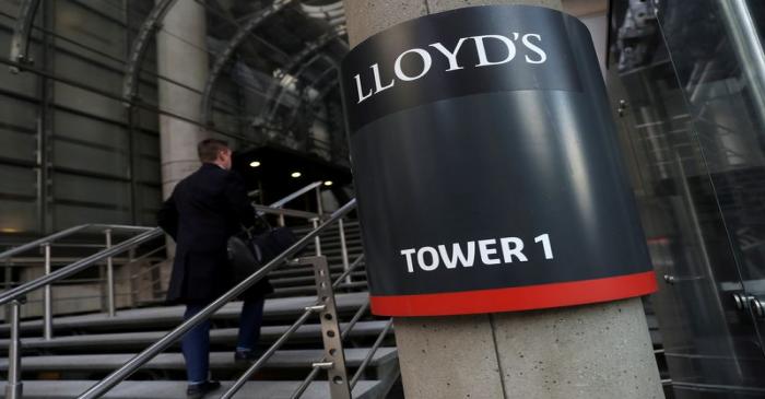 FILE PHOTO: A worker enters the Lloyd's of London building in the City of London financial