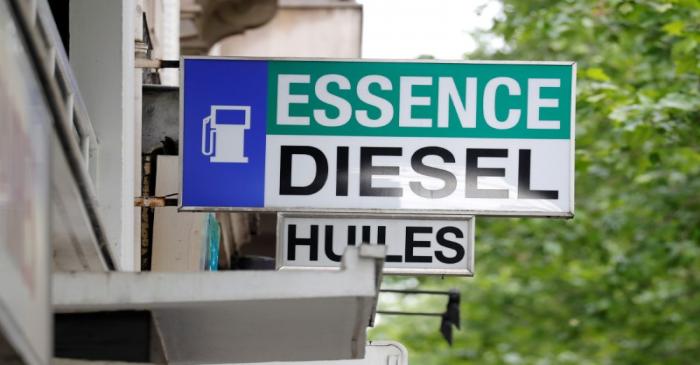 FILE PHOTO:  Signs at a petrol station indate Gas, Diesel, and Oil for vehicles in Paris