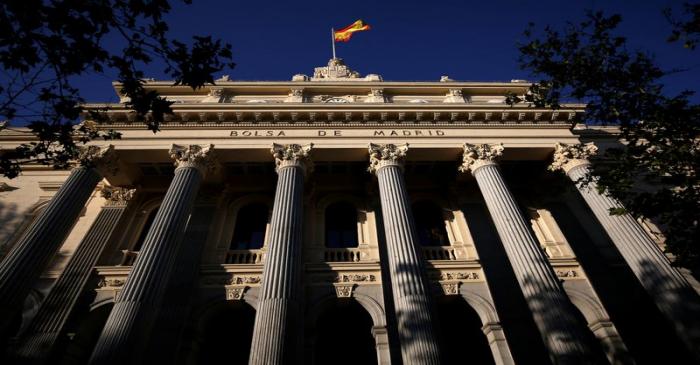 A Spanish flag flutters above the Madrid Stock Exchange