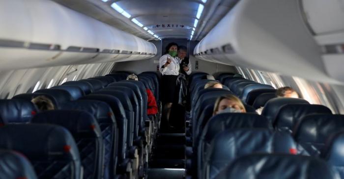 FILE PHOTO: Flight attendants talk in a nearly empty cabin on a Delta Airlines flight operated