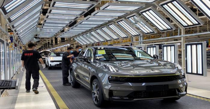 Employees wearing face masks work on a Lynk &Co car production line at Geely's Yuyao plant in