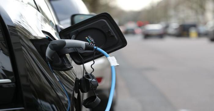 FILE PHOTO: Electric car charges on a street in London