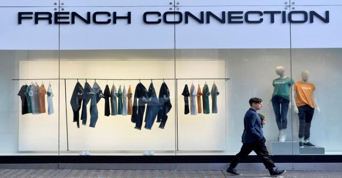 FILE PHOTO: A person walks past a French Connection store in London, Britain