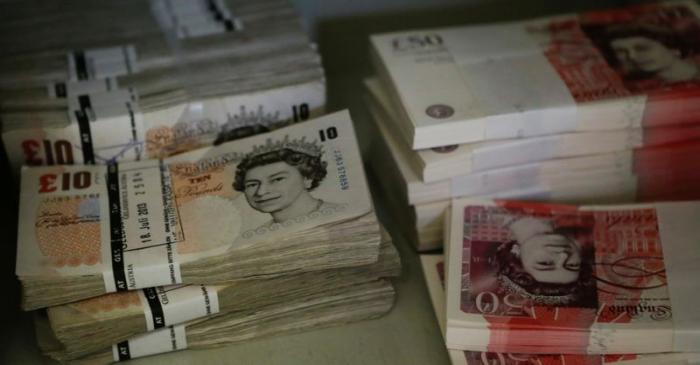 FILE PHOTO: Wads of Pound Sterling banknotes are pictured at the GSA company's headquarters in