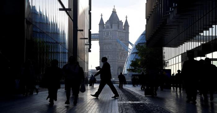FILE PHOTO: Workers are seen in the More London district, with Tower Bridge behind during the