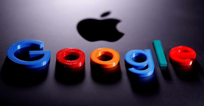 FILE PHOTO: A 3D printed Google logo is placed on the Apple Macbook in this illustration