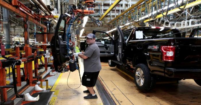 FILE PHOTO: A Ford Motor assembly worker works on a 2018 Ford F150 pick-up truck at Ford's