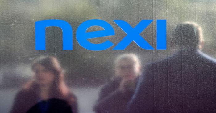 People stand outside the Italian payments group Nexi's headquarters in Milan in Milan