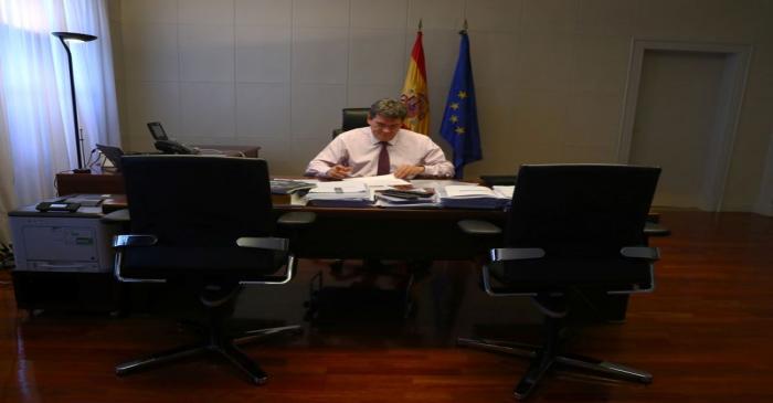 Spain's Social Security Minister, Escriva, works in his office during an interview with Reuters