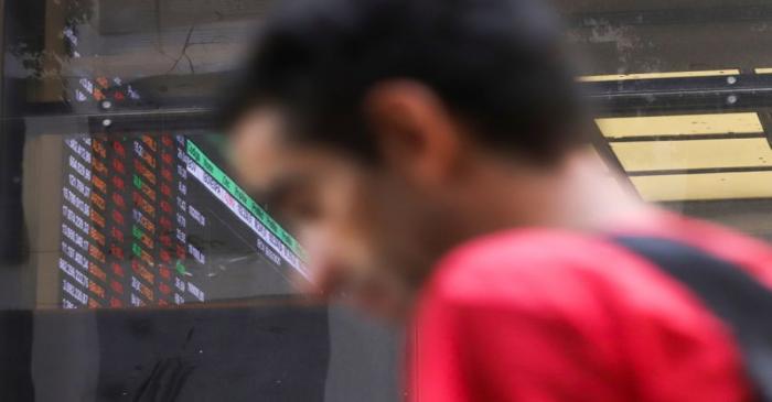 A man passes in front of Brazil's B3 Stock Exchange in Sao Paulo