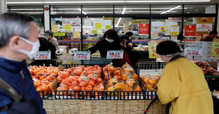 FILE PHOTO: Shoppers wearing protective face masks, following an outbreak of the coronavirus