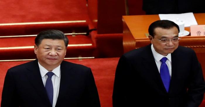 FILE PHOTO: Chinese President Xi Jinping and Premier Li Keqiang arrive for the opening session
