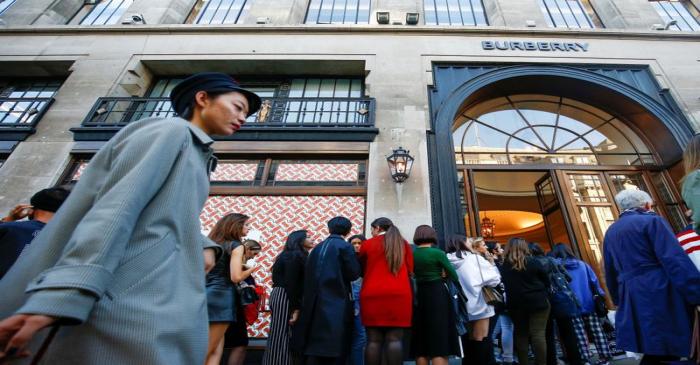 FILE PHOTO: People queue outside a Burberry store on Regent Street, London
