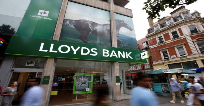 People walk past a branch of Lloyds Bank on Oxford Street in London